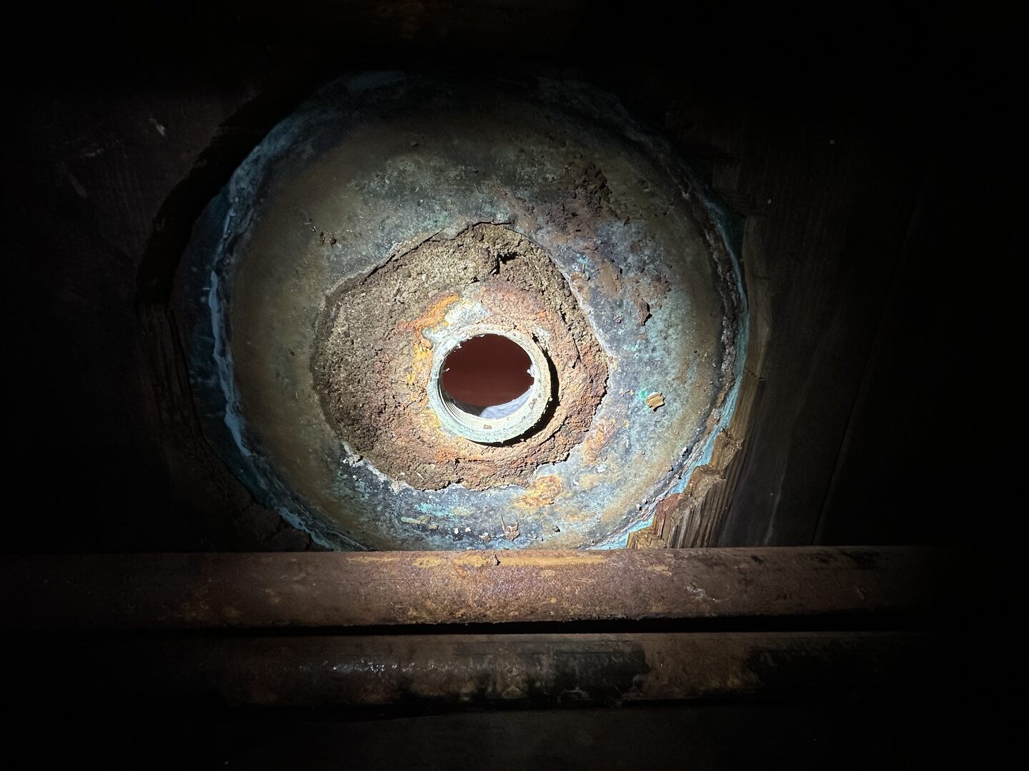 Bottom of shower pan immediately after removing the old barrel trap