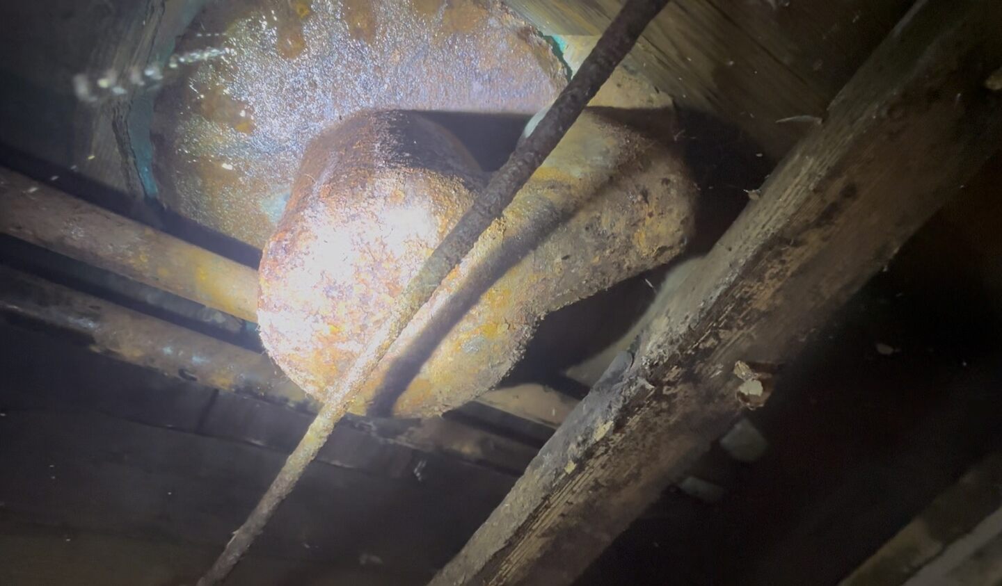 The corroded barrel trap showing clear signs of leaking
