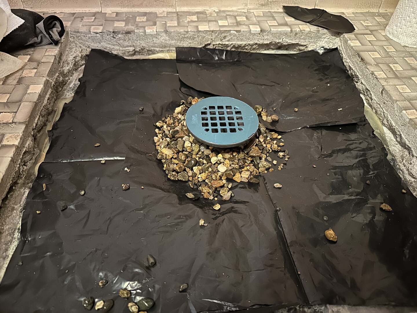 Pea gravel around the drain and isolation plastic